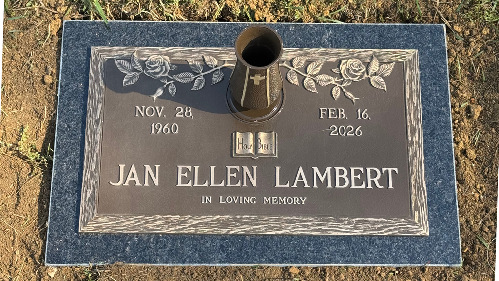 Personalized bronze memorial with rose design and vase mounted on a black granite base