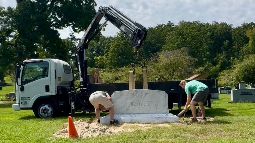 Rico Monuments crew aligning and installing a granite memorial in the Chattanooga area