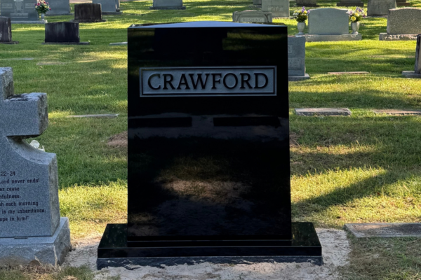 Family monument featuring an apex top and raised letters in Jet Black. Family monument featuring an apex top and raised letters in Jet Black.