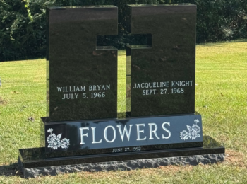 Custom Jet Black Cross Cut out monument sitting on a bevel sub-base. Custom Jet Black Cross Cut out monument sitting on a bevel sub-base.