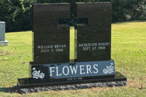 Custom Jet Black Cross Cut out monument sitting on a bevel sub-base.