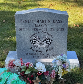 Georgia grey granite single upright headstone with a serpentine top and matching base. Georgia grey granite single upright headstone with a serpentine top and matching base.
