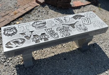 Memorial bench in Georgia Grey granite featuring a straight seat and harp-style legs. Memorial bench in Georgia Grey granite featuring a straight seat and harp-style legs