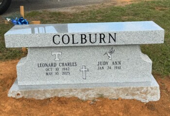 Memorial bench in Georgia Grey granite featuring a straight seat design with pedestal support and matching base. Memorial bench in Georgia Grey granite featuring a straight seat design with pedestal support and matching base.