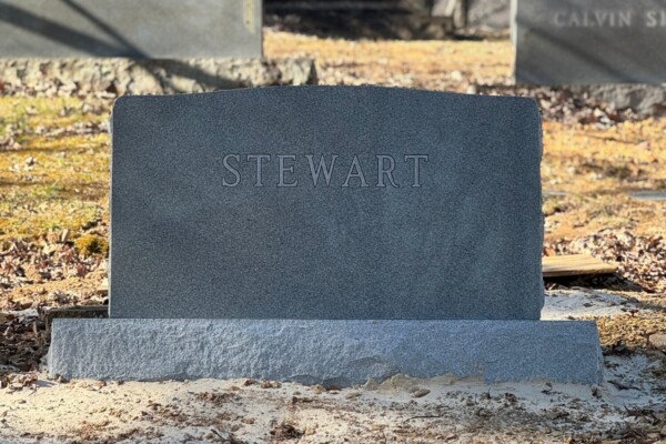 Family monument in Georgia Grey granite featuring a serpentine top and detailed double outline lettering. Family monument in Georgia Grey granite featuring a serpentine top and detailed double outline lettering.