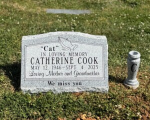 Georgia Grey granite slant headstone with a serpentine top, polished face and a vase. Georgia Grey granite slant headstone with a serpentine top, polished face and a vase.