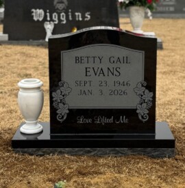Jet Black granite single upright monument with contrasting panel inscription and polished margin base. Jet Black granite single upright monument with contrasting panel inscription and polished margin base.